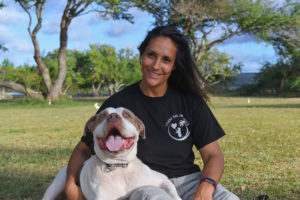Maria and her dog Lono at the park after training in Hawaii