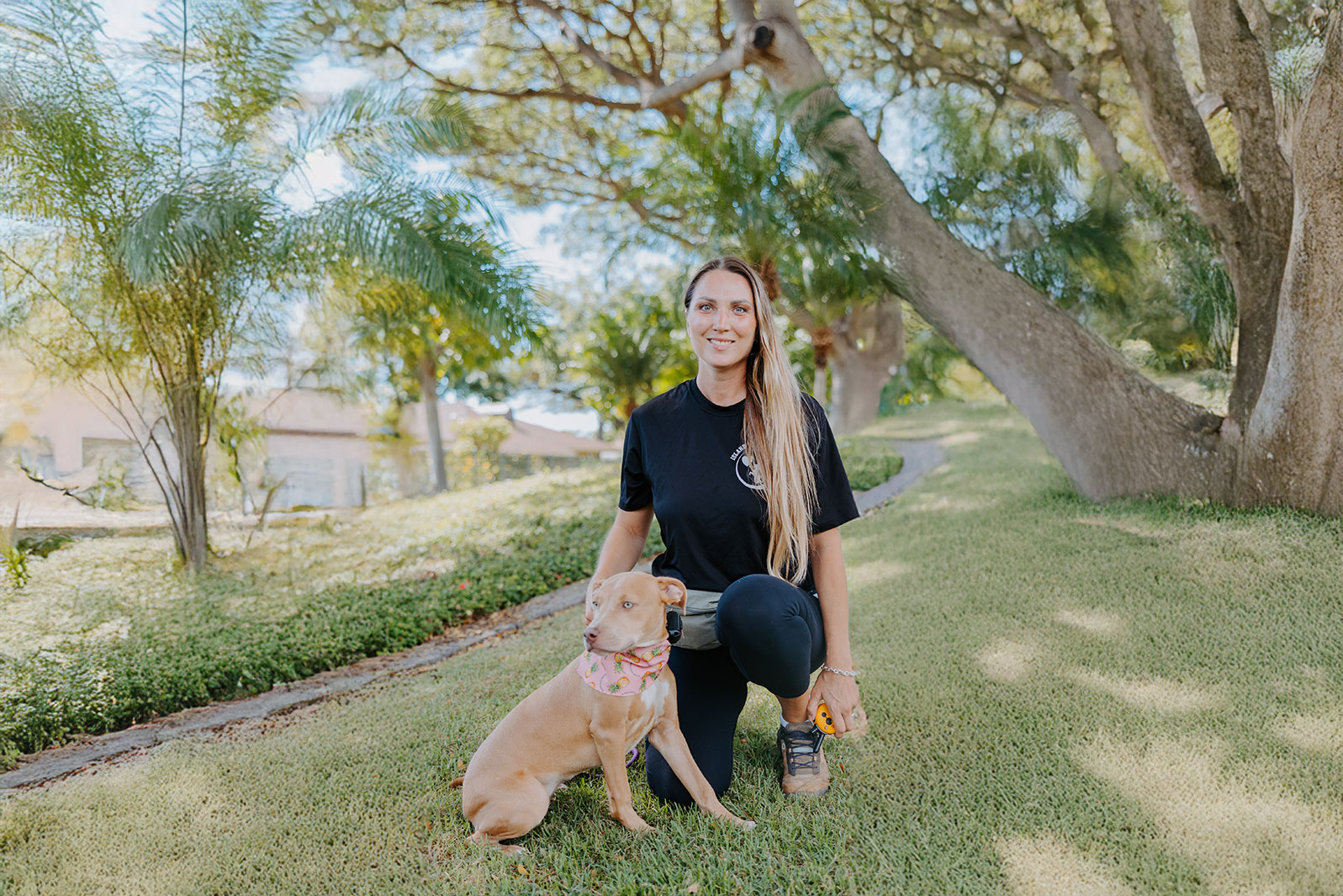 Raya training a dog at a park in Hawaii