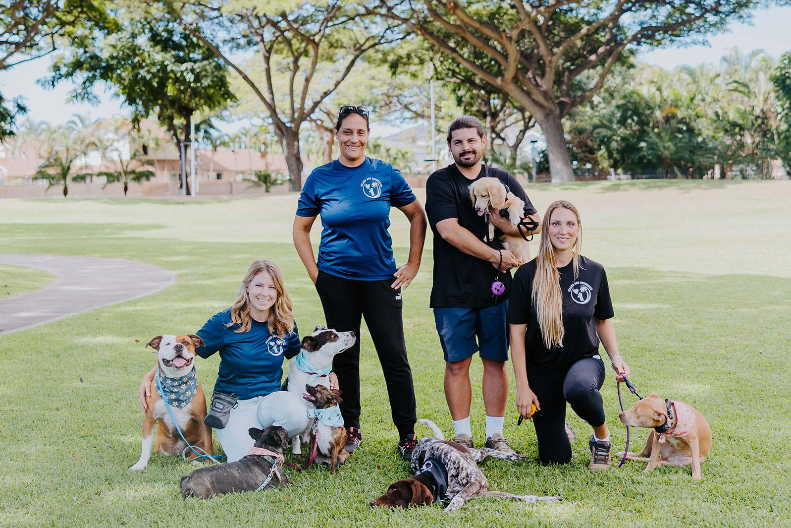 The Island Dog Obedience team with their trained dogs at an Oahu park